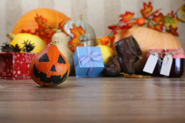 Pumpkin on the floor with candle lantern and candy