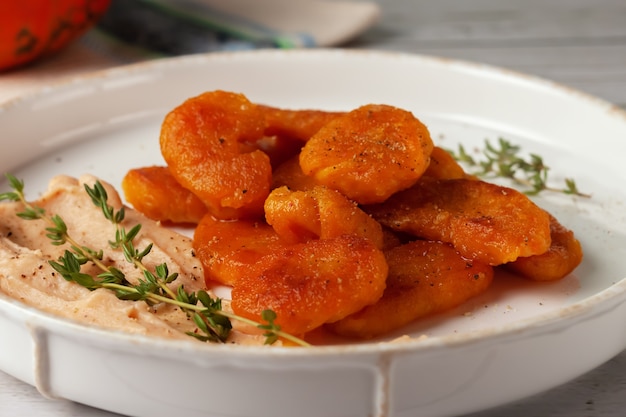 Pumpkin gnocchi with Morne sauce on a plate. Horizontal view