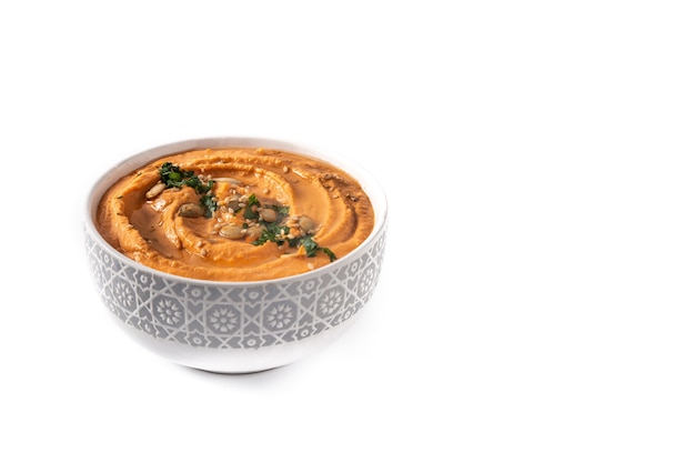 Pumpkin hummus in bow isolated on white