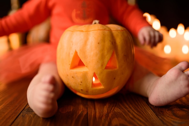 Photo pumpkin jack close-up, near the legs of a little girl