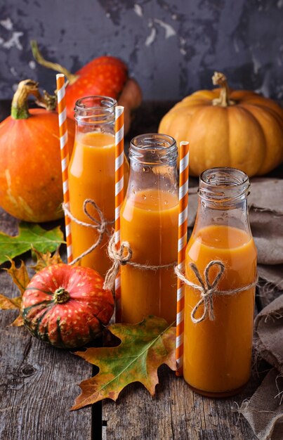 Pumpkin juice in bottles. Autumn healthy drink