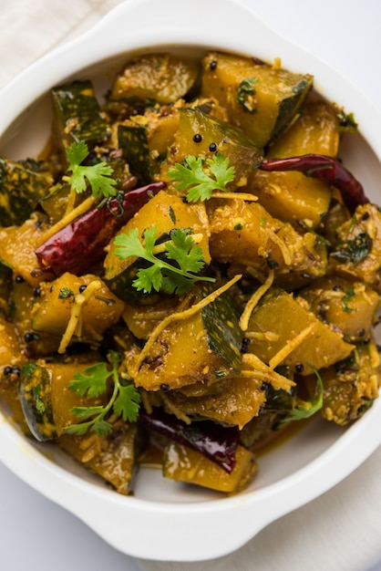 Pumpkin OR Kaddu ki Sabzi served in a bowl over moody background, selective focus