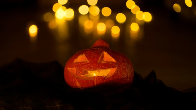 Pumpkin lantern on the background of lights