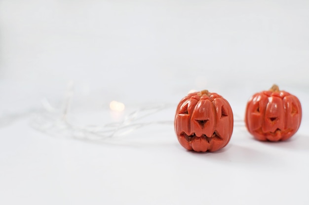 Pumpkin made of orange plasticine with eyes and mouth cut out