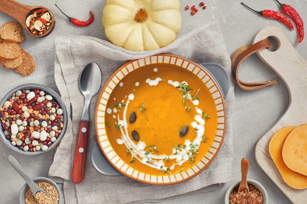 Pumpkin, mixed beans and sweet potato creme soup in ceramic bowl