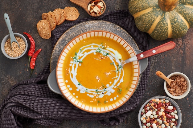 Pumpkin, mixed beans and sweet potato creme soup in ceramic bowl,