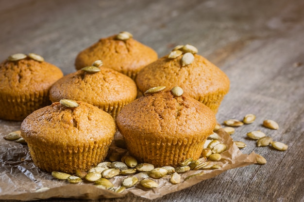 Pumpkin muffins on wood.