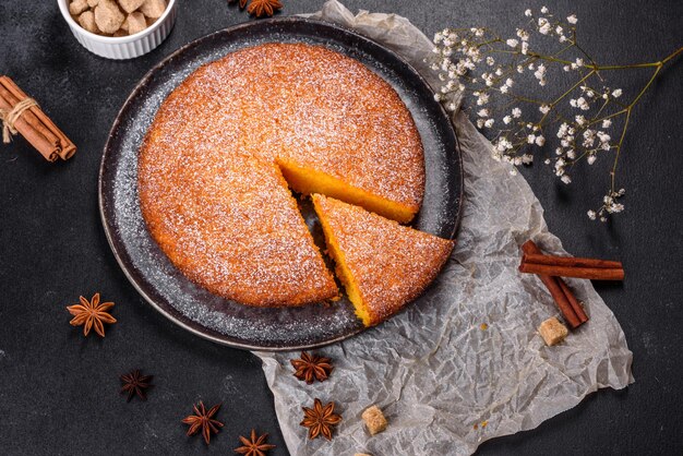 Pumpkin pie on marble cutting board Dark background Copy space