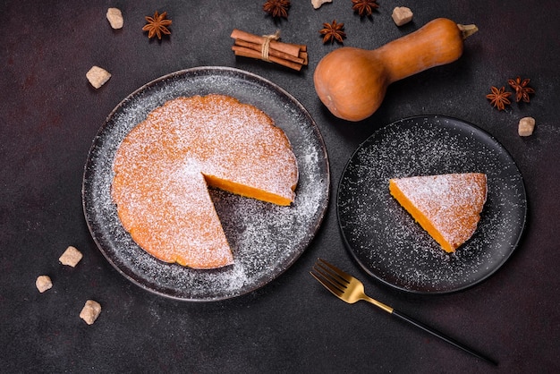 Pumpkin pie tart made for Thanksgiving day with whipped cream on a black plate