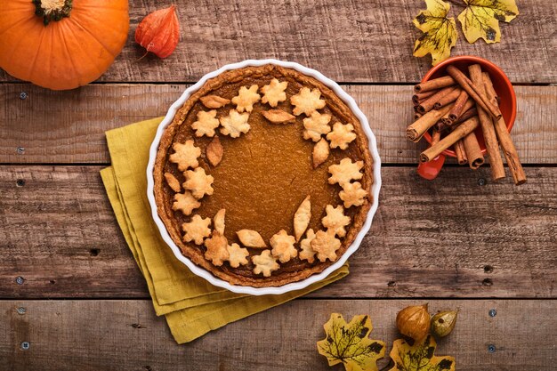 Pumpkin Pie. Tart with whipped cream and cinnamon on rustic background. Traditional american homemade pumpkin cake for Thanksgiving or Halloween Ready to eat. Mock up.