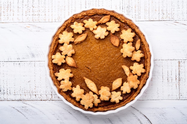 Pumpkin Pie. Tart with whipped cream and cinnamon on white rustic background. Traditional american homemade pumpkin cake for Thanksgiving or Halloween Ready to eat. Mock up.