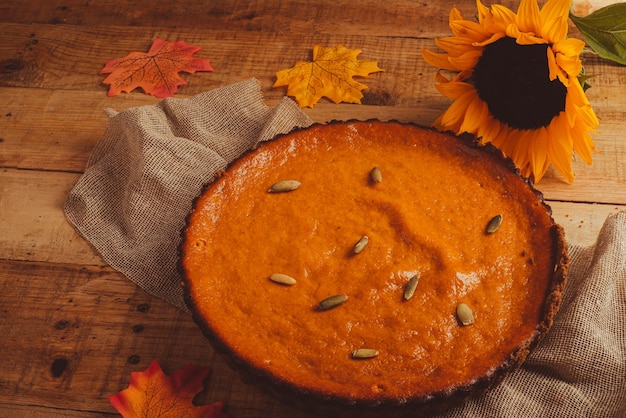 Pumpkin pie on wooden table. Dessert for thanksgiving dinner and pumpkin on wooden table.