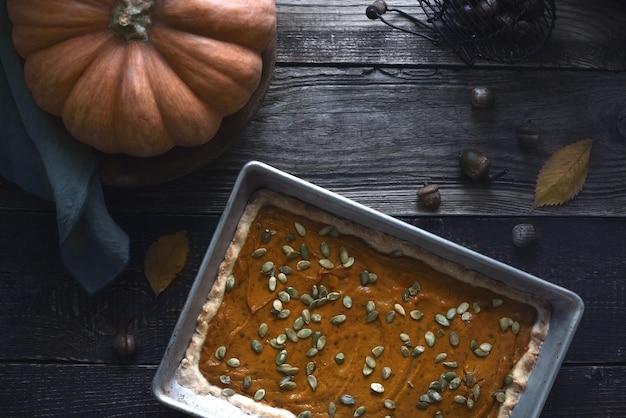 Pumpkin pie on the wooden table with autumn gift horizontal