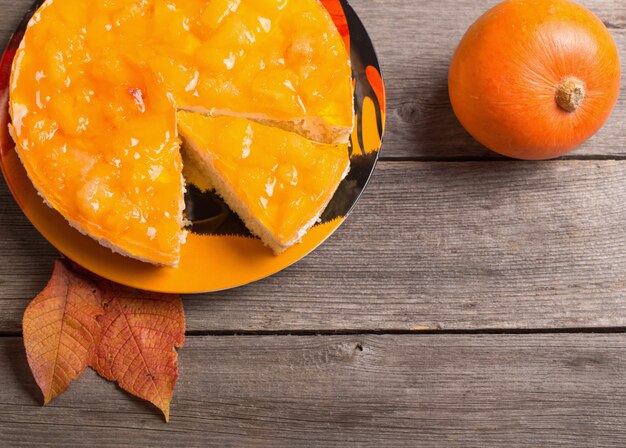 Pumpkin and pie on wooden table