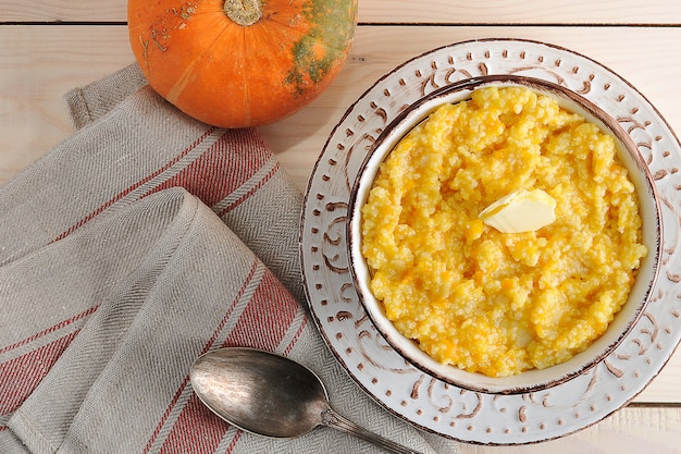 Pumpkin porridge with butter and a pumpkin 