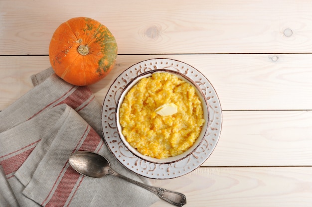 Pumpkin porridge with butter and a pumpkin 