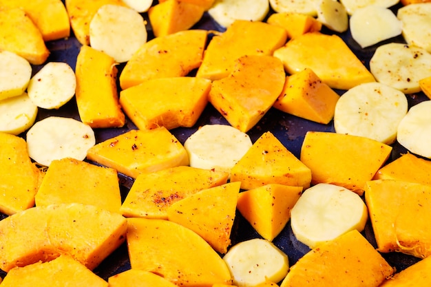 Pumpkin and potatoes on a baking tray