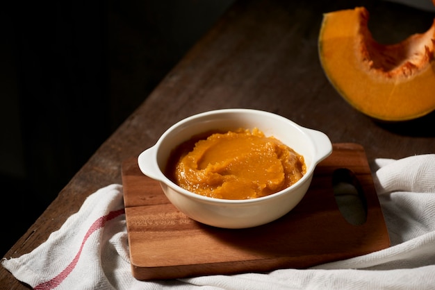 Pumpkin puree in a bowl on wooden table