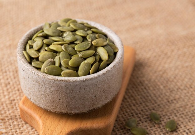 Pumpkin seeds in a bowl superfoods Copy space