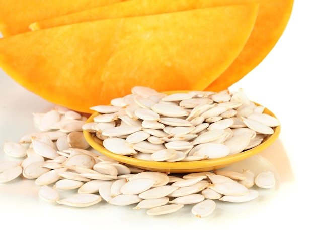 Pumpkin seeds on color plate isolated on the white