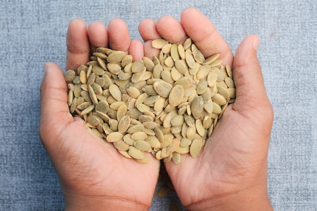 Pumpkin seeds on hand close up