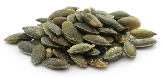 Pumpkin seeds roasted and salty over white background