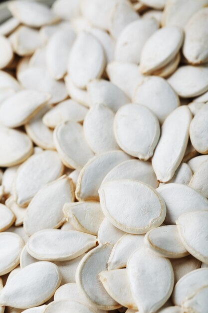 Pumpkin seeds in a shell as a textural background.