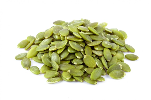 Pumpkin seeds on a white wall. 