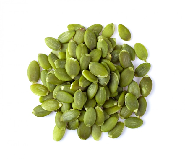 Pumpkin seeds on a white wall. 