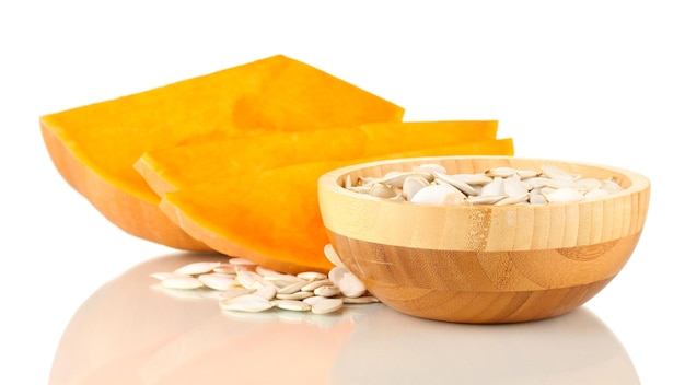 Pumpkin seeds in wooden bowl isolated on the white