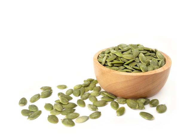 Pumpkin seeds in wooden bowl with Heap pumpkin seeds.