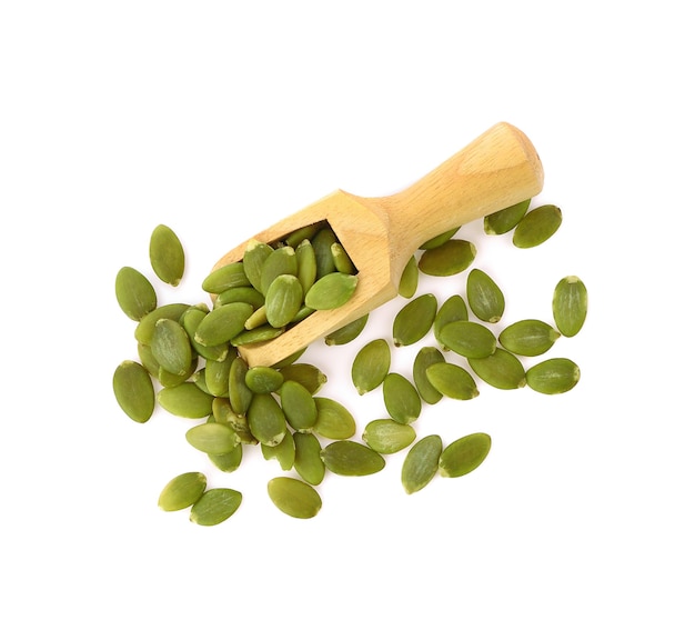 Pumpkin seeds in wooden scoop isolated on white background