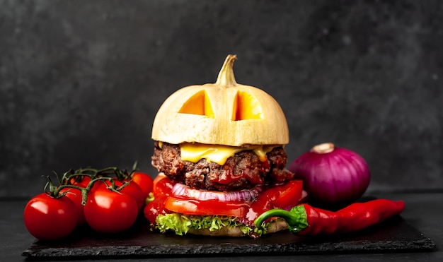 pumpkin-shaped burger for Halloween holiday on stone wall