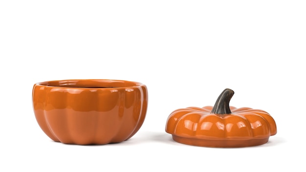 A pumpkin-shaped clay pot with a lid isolated on a white background. Colorful tableware for the holiday.