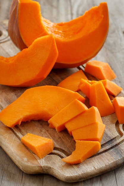 Pumpkin slices on a white wooden background close up