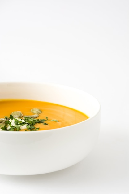 Pumpkin soup in bowl isolated on white