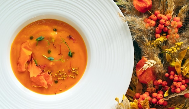 Pumpkin soup on a green background. the view from the top