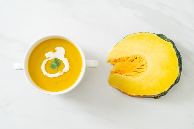 pumpkin soup in white bowl - Vegetarian and vegan food style