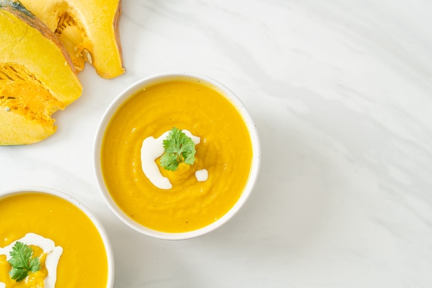 pumpkin soup in white bowl - Vegetarian and vegan food style