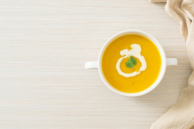 Pumpkin soup in white bowl