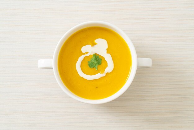 Pumpkin soup in white bowl