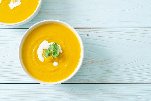 Pumpkin soup in white bowl