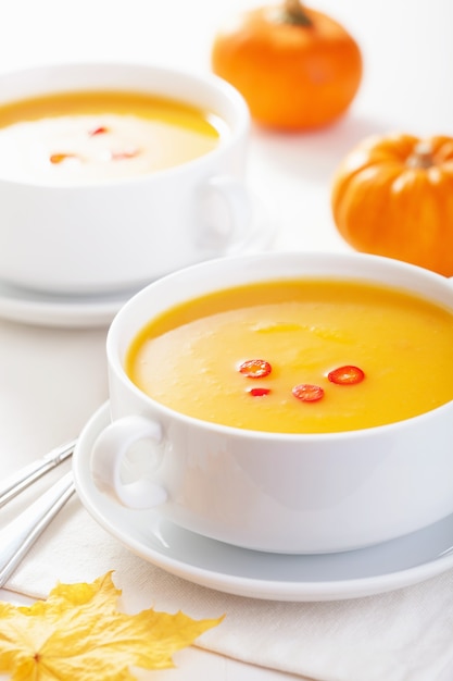 Pumpkin soup in white bowl