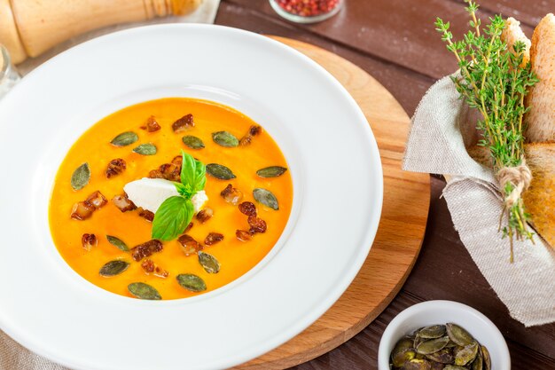 Pumpkin soup in white plate