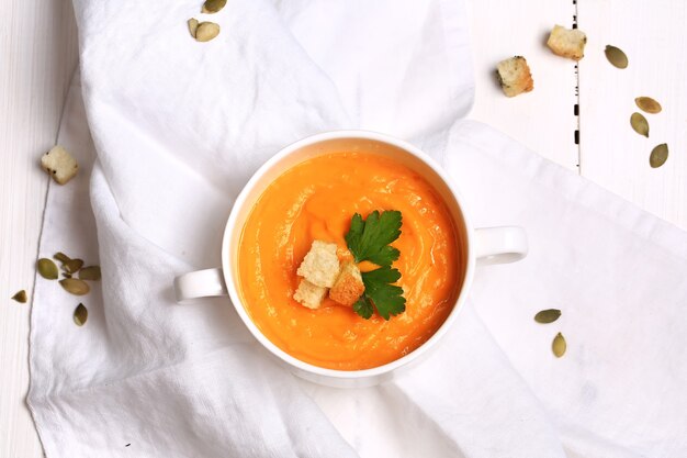 Pumpkin soup with garlic croutons top view