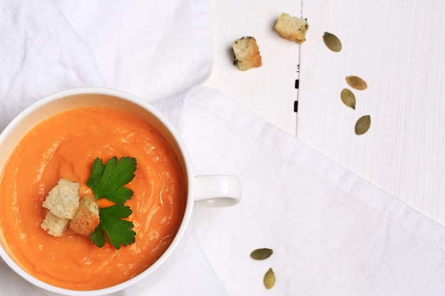 Pumpkin soup with garlic croutons top view