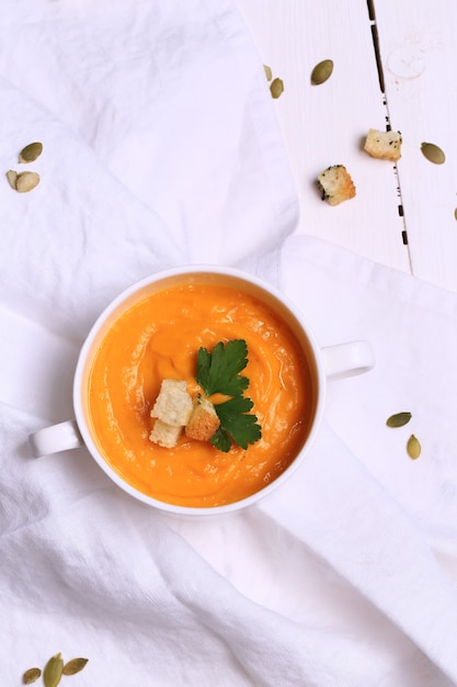 Pumpkin soup with garlic croutons top view