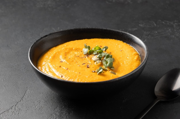 Pumpkin soup with greens garnish