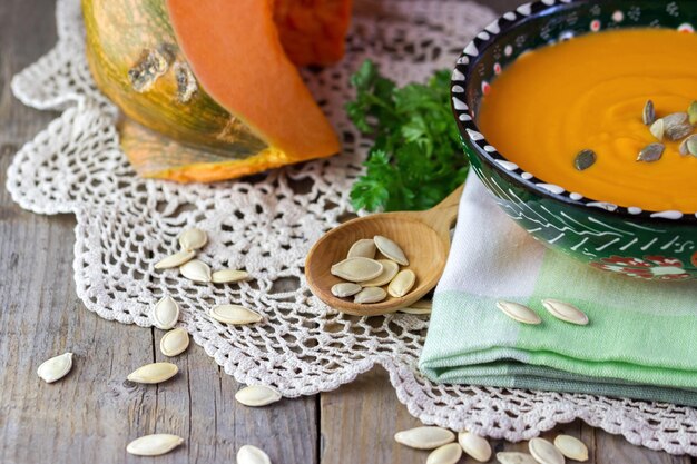 Pumpkin soup with seeds on a napkin on the table