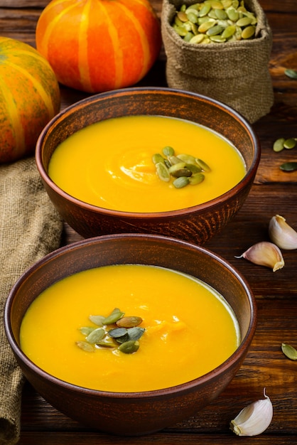 Pumpkin soup on wooden background